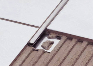Ragasztórétegbe ágyazott különféle adottságú szegélyidomokkal főként kis szintkülönbségű padlófelületeket lehet összekapcsolni